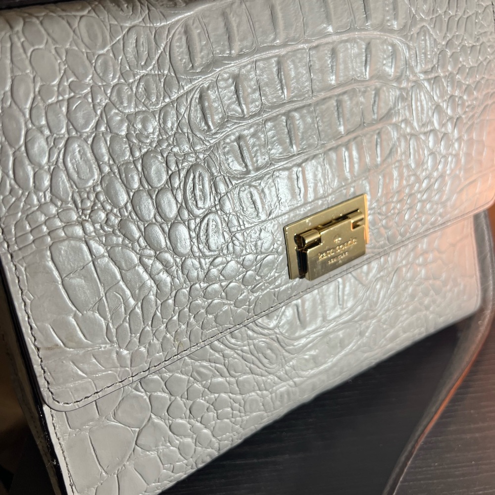 Grey Kate spade bag. Tag included in pic . Just like new .